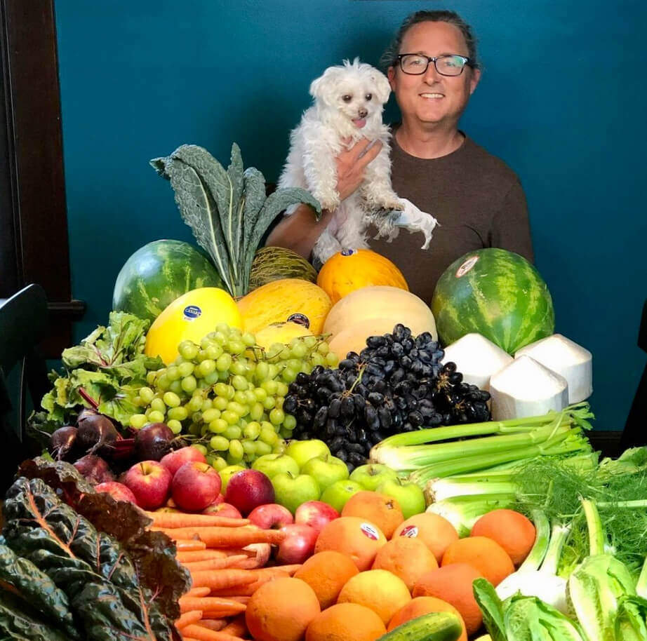 Brett with dog and fruit and veggies