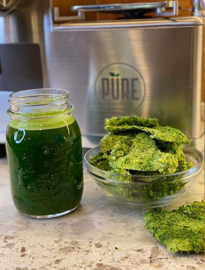 Green juice in front of PURE Juicer