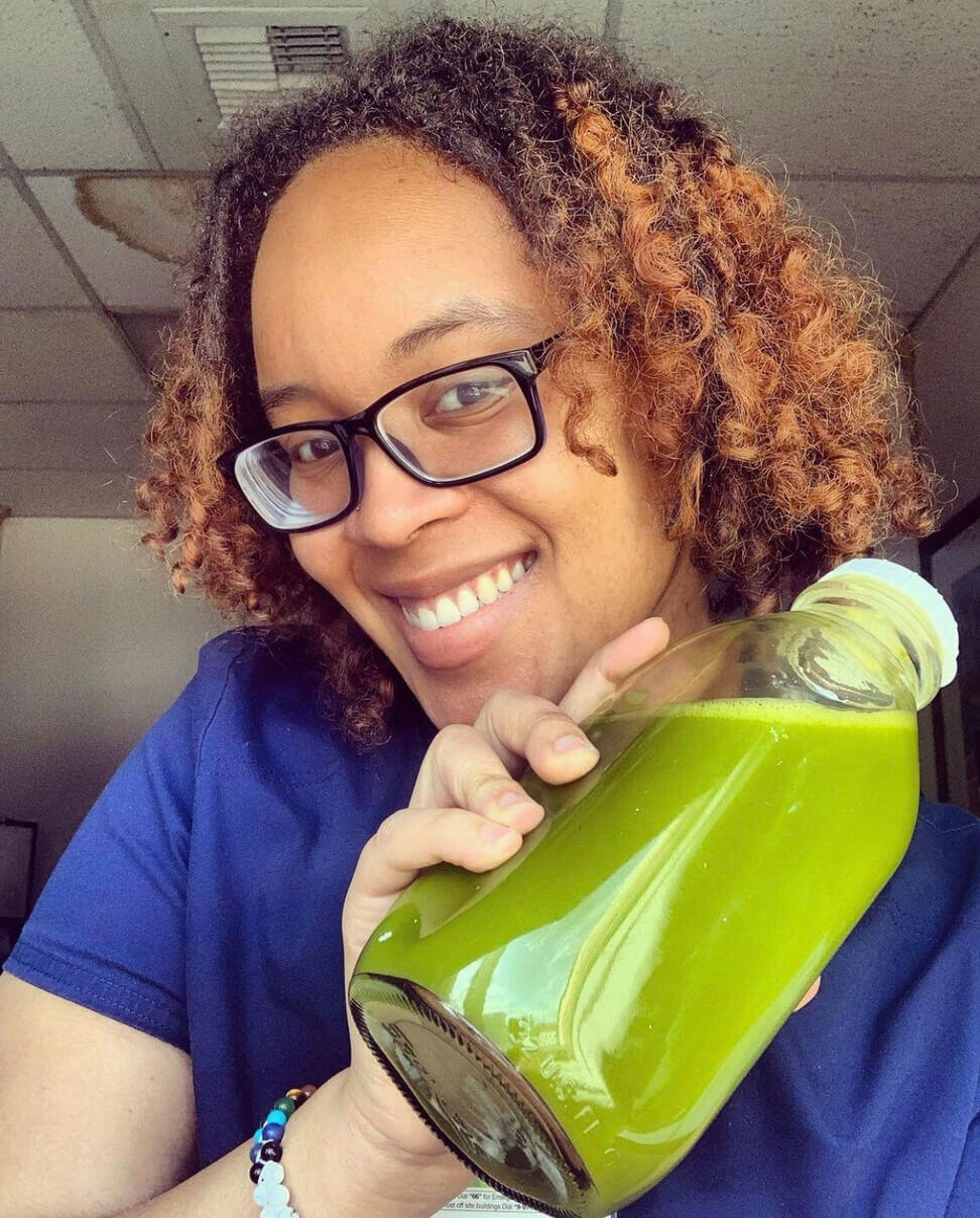 Kia Sanders holding green juice