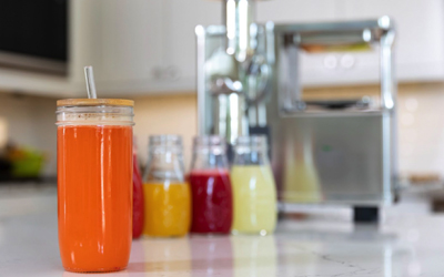 multiple types of juices in front of pure juicer