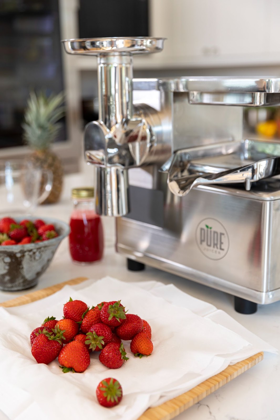 Strawberries in front of pure juicer