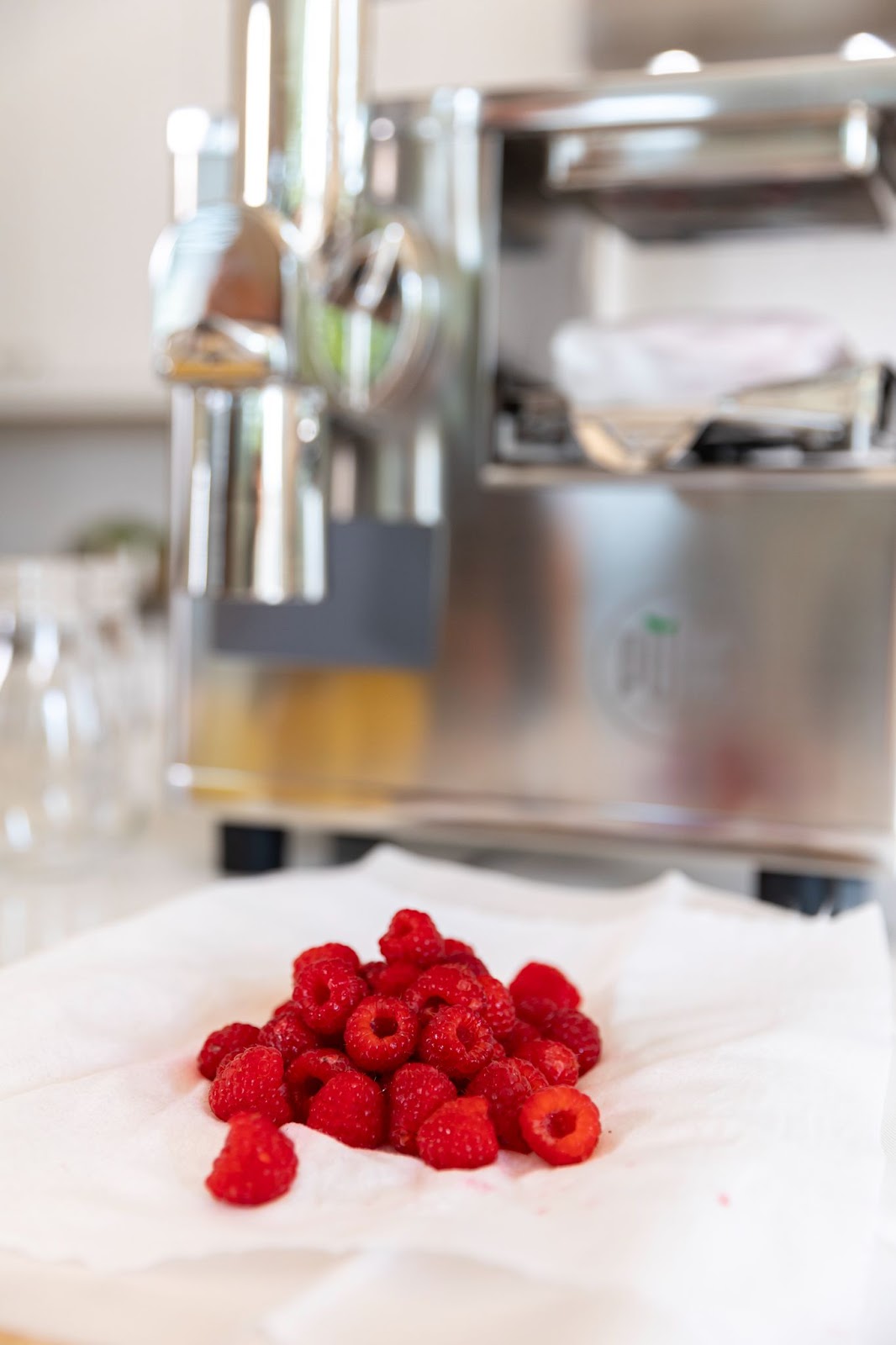 raspberries in front of pure juicer