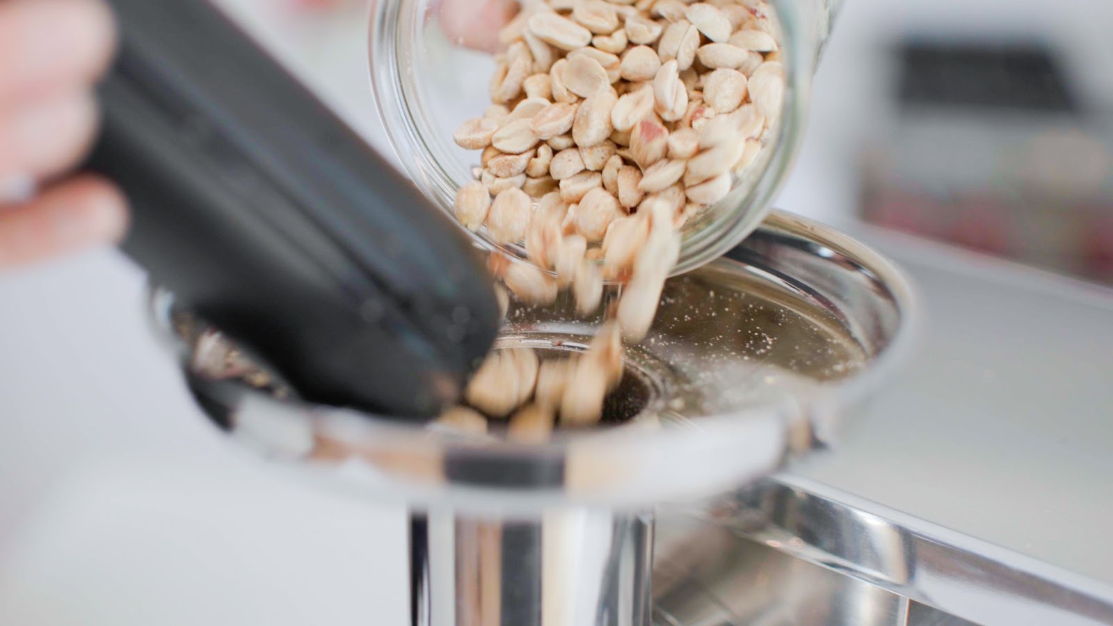 pouring nuts into juicer