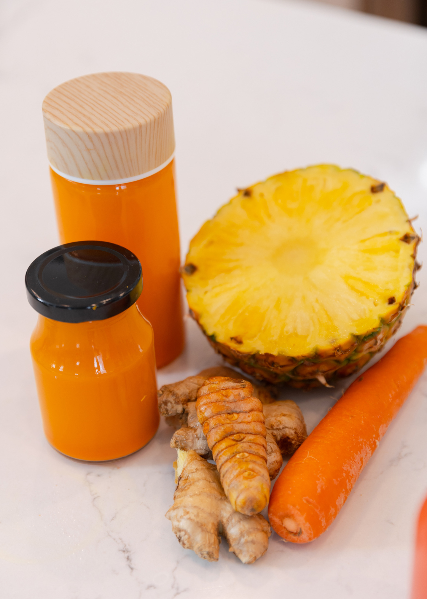 pineapple, carrot and ginger juice in a jar